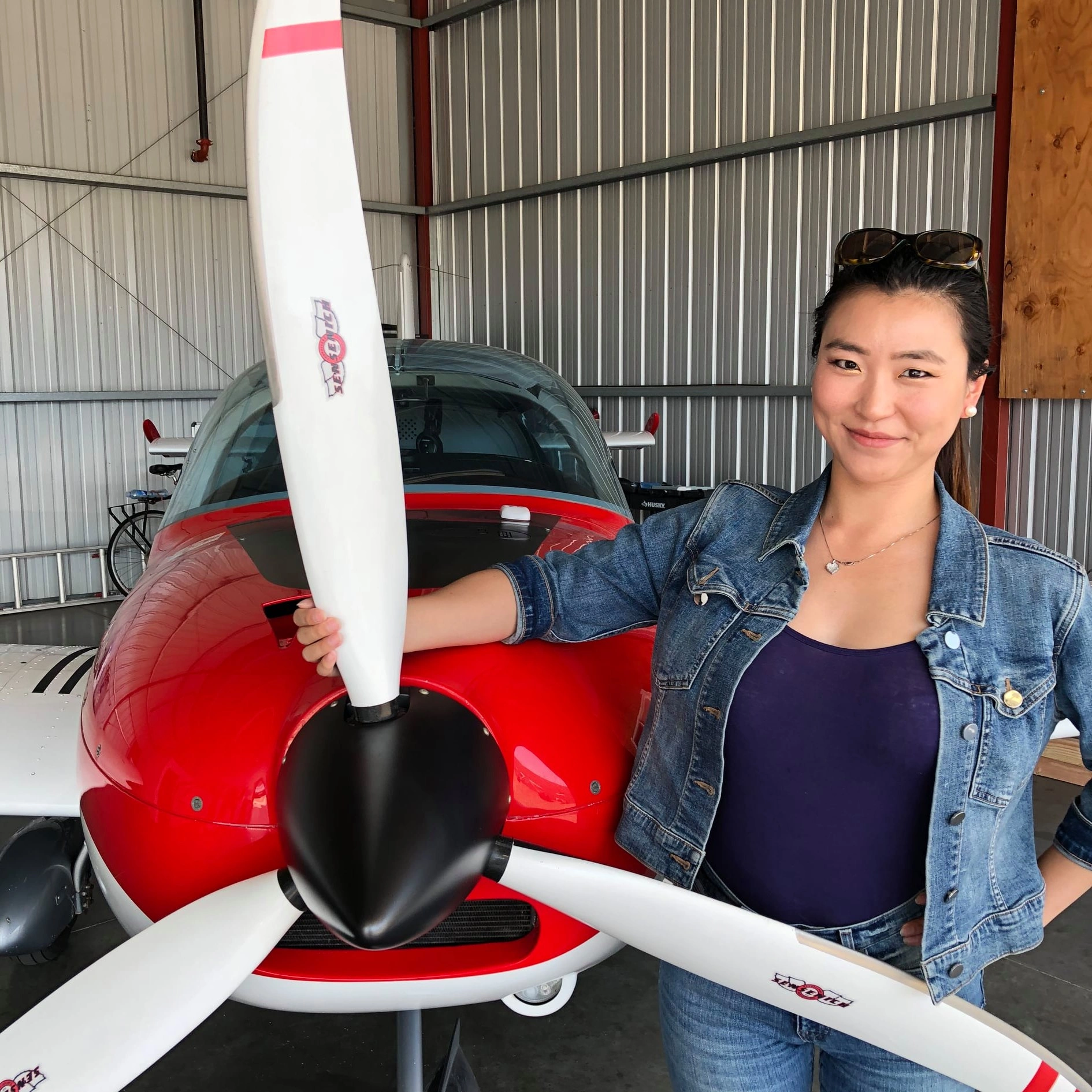 Flight student standing proudly in front of a modern training aircraft
