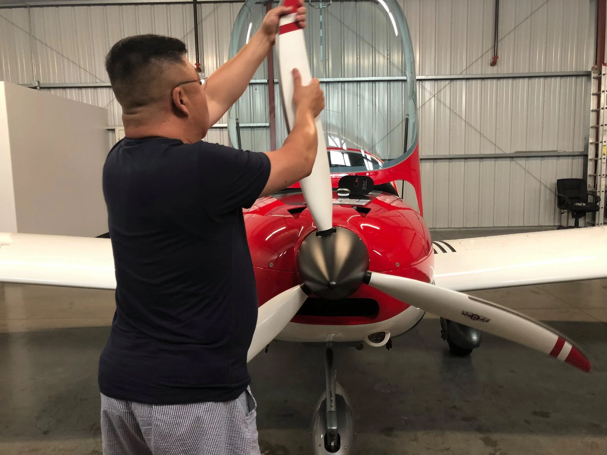 Student inspecting aircraft flaps before a flight