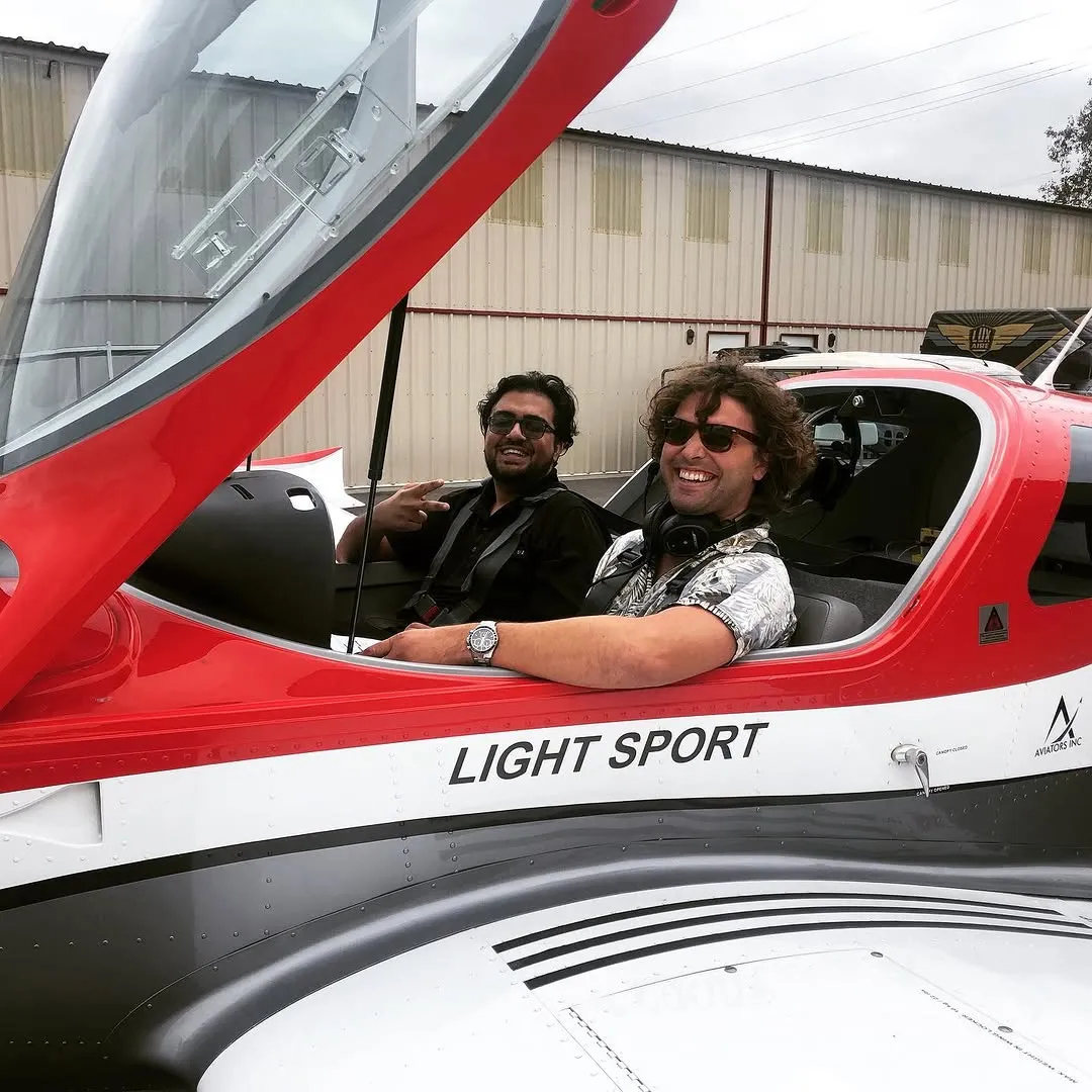 Student and instructor smiling inside an aircraft